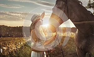 Cheerful, attractive woman with a majestic horse