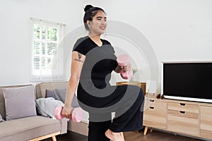 Cheerful attractive young overweight woman in activewear choosing healthy lifestyle