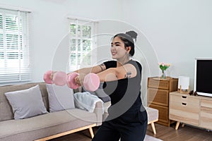 Cheerful attractive young overweight woman in activewear choosing healthy lifestyle