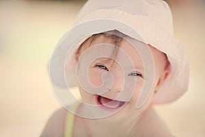 Cheerful baby girl with Downs Syndrome playing in the pool photo