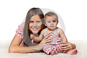 Cheerful baby girl with smiling mother