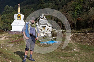 Cheerful bandit keffieh knife standing buddhist religious stupa photo