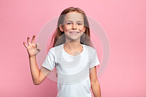 Cheerful beautiful blonde girl showing okay sign