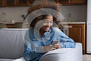 Cheerful beautiful gen Z teenage African girl using virtual app