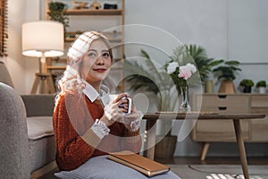 cheerful beautiful pretty asian woman smiling happy relaxing drinking of hot coffee or tea.Girl felling enjoy having in
