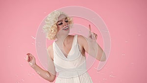 Cheerful beautiful young woman surrounded by soap bubbles. Woman looking like Marilyn Monroe excitedly saying wow and