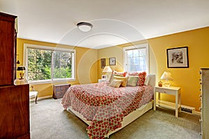 Cheerful bedroom interior in bright yellow color