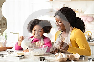 Cheerful Black Family Mother And Daughter Baking Together In Kitchen