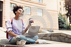 Cheerful Black Girl Chatting Via Video Call On Laptop Outdoor