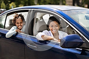 Cheerful Black Mother And Daughter Sitting In New Auto