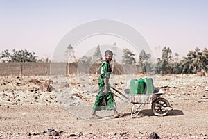 Cheerful Black Woman Engaged with Tap Water for an aridity concept