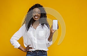 Cheerful black woman showing latest slim cellphone