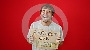 Cheerful blond bloke doubling over laughing at a hilarious joke, while boldly flaunting \'protect our planet\' banner against a