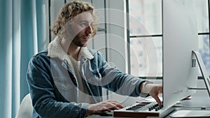 Cheerful blond musician composes melody on electric piano