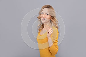 cheerful blonde beauty woman touch curly hair, copy space, hairdresser