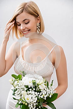 cheerful and blonde bride in wedding