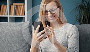 Cheerful blonde using smartphone