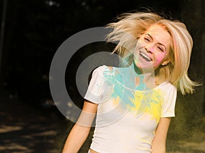 Cheerful blonde woman in white t shirt with hair in wind covered