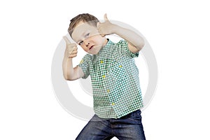 Cheerful boy in a green shirt showing a thumb up on a white background. Isolated