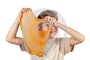 Cheerful boy holding a slime and looking throw its hole.