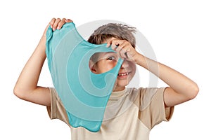 Cheerful boy holding a turquoise color slime toy