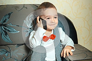 Cheerful boy talking phone