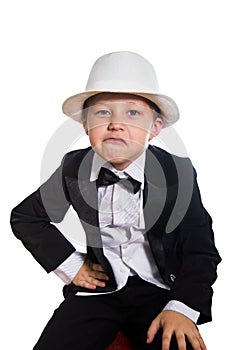 Cheerful boy in a tuxedo, hat.