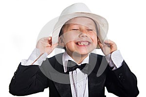 Cheerful boy in a tuxedo and hat.