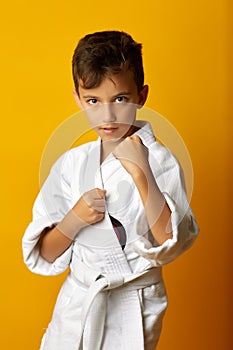 Cheerful boy in white kimono smiling at camera