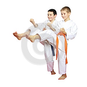 Cheerful boys athletes train beat blows kicks