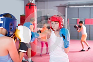 Cheerful boys and girl practicing boxing punches