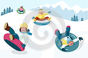 Cheerful boys and girls slide down the hill on snow tubing