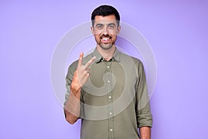 cheerful brunette bearded man demonstrating the letter V v