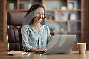 Cheerful brunette woman having online job interview from home