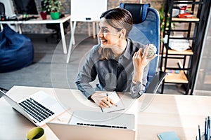 Cheerful brunette woman working in the office