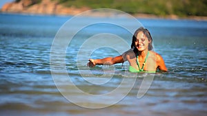 Cheerful brunette young woman in the sea water