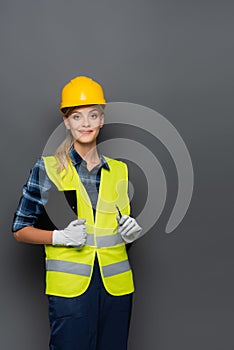 Cheerful builder in hardhat looking at