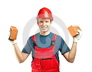 Cheerful builder holding bricks