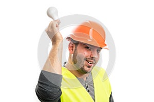 Cheerful builder holding lightbulb as good idea concept
