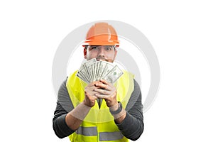 Cheerful builder man presenting cash money as payment concept