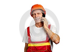 Cheerful builder talking on cell phone.
