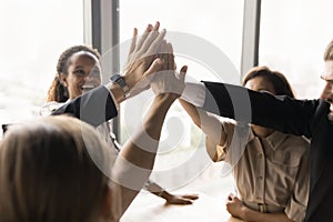 Cheerful business colleagues high five gesture close up