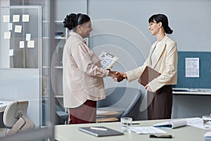 Cheerful Business Ladies Greeting Each Other in Office