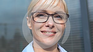 Cheerful business lady in glasses looking to camera feeling proud and inspired