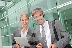 Cheerful business partners using tablet