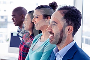 Cheerful business team standing in row