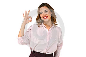 Cheerful business woman showing ok sign