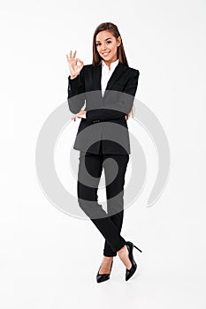 Cheerful business woman showing okay gesture