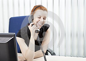 Cheerful business woman on a telephone