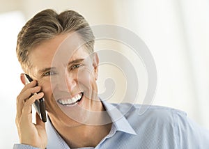 Cheerful Businessman Answering Smart Phone